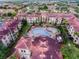 Aerial view of community featuring multiple buildings and a pool at 902 Charo Pkwy # 636, Davenport, FL 33897