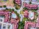 Aerial view of community with multiple buildings and pools at 902 Charo Pkwy # 636, Davenport, FL 33897