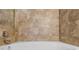 Close up of a bathtub with tan tile surround at 902 Charo Pkwy # 636, Davenport, FL 33897