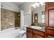Clean bathroom with tub, shower, granite vanity, and updated fixtures at 902 Charo Pkwy # 636, Davenport, FL 33897