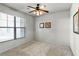 Bright bedroom with large window, ceiling fan, and neutral carpeting at 902 Charo Pkwy # 636, Davenport, FL 33897