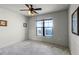 Bright bedroom with window, ceiling fan, and neutral decor at 902 Charo Pkwy # 636, Davenport, FL 33897