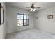 Well-lit bedroom featuring a large window and ceiling fan at 902 Charo Pkwy # 636, Davenport, FL 33897