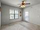 Bright bedroom with carpeted floor, large window, and access to a balcony at 902 Charo Pkwy # 636, Davenport, FL 33897