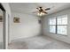 Bedroom with window, ceiling fan, and neutral wall colors at 902 Charo Pkwy # 636, Davenport, FL 33897