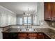 Kitchen with granite counters, double sink, and wood cabinets at 902 Charo Pkwy # 636, Davenport, FL 33897