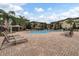 Resort-style pool with lounge chairs and shaded seating areas at 902 Charo Pkwy # 636, Davenport, FL 33897