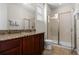 Bathroom with shower, toilet, granite countertop, and dark wood cabinets at 7639 Wilmington Loop, Kissimmee, FL 34747
