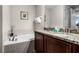 Bathroom with a garden tub and double vanity at 7639 Wilmington Loop, Kissimmee, FL 34747