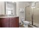 Bathroom with shower, toilet, granite countertop, and dark wood cabinets at 7639 Wilmington Loop, Kissimmee, FL 34747