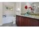 Bathroom with granite countertops, double vanity, and soaking tub at 7639 Wilmington Loop, Kissimmee, FL 34747