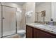 Bathroom with shower, toilet, granite countertop, and dark wood cabinets at 7639 Wilmington Loop, Kissimmee, FL 34747