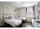 Bedroom with two twin beds, light wood furniture, and soft decor at 7639 Wilmington Loop, Kissimmee, FL 34747