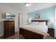 Main bedroom with king-size bed and ensuite access at 7639 Wilmington Loop, Kissimmee, FL 34747