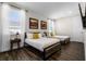 Guest bedroom with two twin beds, wood flooring, and neutral decor at 7639 Wilmington Loop, Kissimmee, FL 34747