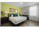 Bedroom with king-size bed, wood floors, and accent wall at 7639 Wilmington Loop, Kissimmee, FL 34747