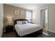 Main bedroom with a king-size bed and ensuite bathroom at 7639 Wilmington Loop, Kissimmee, FL 34747