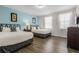 Bedroom with two double beds, wood floors, and light blue wall at 7639 Wilmington Loop, Kissimmee, FL 34747