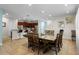 Dining room with large table and chairs, adjacent to kitchen and living room at 7639 Wilmington Loop, Kissimmee, FL 34747