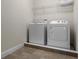 Laundry room with washer and dryer, tiled floor, and overhead shelving at 7639 Wilmington Loop, Kissimmee, FL 34747