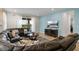 Open living area with sectional sofa, large TV, and access to outdoor space at 7639 Wilmington Loop, Kissimmee, FL 34747