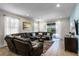 Spacious living room featuring a large sectional sofa and access to the backyard at 7639 Wilmington Loop, Kissimmee, FL 34747