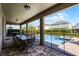 Covered patio with dining table and adjacent pool and spa at 7639 Wilmington Loop, Kissimmee, FL 34747