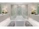 Luxurious bathroom featuring a large soaking tub and walk-in shower at 812 Desert Mountain Ct, Reunion, FL 34747