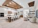 Modern kitchen with large island, white cabinets, and wood ceiling beams at 812 Desert Mountain Ct, Reunion, FL 34747