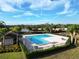 Community pool with patio furniture and palm trees at 110 Claire Ln, Davenport, FL 33837