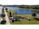 Community entrance with pond and landscaping at 12749 Brodlove Lane, Winter Garden, FL 34787