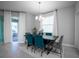 Dining room with dark wood table and teal chairs at 12749 Brodlove Lane, Winter Garden, FL 34787