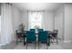 Dining room with dark wood table and teal chairs at 12749 Brodlove Lane, Winter Garden, FL 34787
