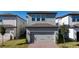Two-story house with gray siding, attached garage, and landscaping at 12749 Brodlove Lane, Winter Garden, FL 34787