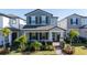 Two-story house with gray siding, landscaping, and a walkway at 12749 Brodlove Lane, Winter Garden, FL 34787