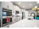 Modern kitchen with white cabinets and stainless steel appliances at 12749 Brodlove Lane, Winter Garden, FL 34787