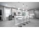 Modern kitchen with white cabinets, island, and stainless steel appliances at 12749 Brodlove Lane, Winter Garden, FL 34787