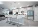Modern kitchen with white cabinets, island, and stainless steel appliances at 12749 Brodlove Lane, Winter Garden, FL 34787