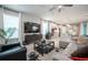 Open-concept living room with kitchen views, comfortable seating and large TV at 12749 Brodlove Lane, Winter Garden, FL 34787