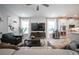 Open concept living space with comfortable seating, a large TV, and views into the kitchen at 12749 Brodlove Lane, Winter Garden, FL 34787