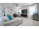 Bright living room featuring a large sectional sofa, smart TV, and stylish decor at 12749 Brodlove Lane, Winter Garden, FL 34787
