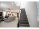 Elegant staircase leading to the upper level of the home with views to the living area at 12749 Brodlove Lane, Winter Garden, FL 34787