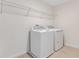 Laundry room with washer, dryer, and overhead shelving at 1734 Carnelian St, Deland, FL 32720