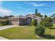 One-story home with a two-car garage and well-manicured lawn at 1878 Monte Cristo Ln, Kissimmee, FL 34758