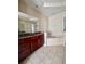 Bathroom with a large soaking tub, double vanity, and tile floors at 2018 Gold Spring Cv, Kissimmee, FL 34743