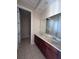 Double vanity bathroom with dark wood cabinets at 2018 Gold Spring Cv, Kissimmee, FL 34743