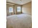 Bright bedroom with neutral colored carpeting and two windows at 2018 Gold Spring Cv, Kissimmee, FL 34743