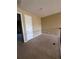 Small bedroom with carpeted floors and a door to hallway at 2018 Gold Spring Cv, Kissimmee, FL 34743