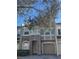 Two-story townhome with stone and beige exterior at 2018 Gold Spring Cv, Kissimmee, FL 34743