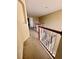 Upstairs hallway with carpet and wooden railings leading to bedrooms at 2018 Gold Spring Cv, Kissimmee, FL 34743